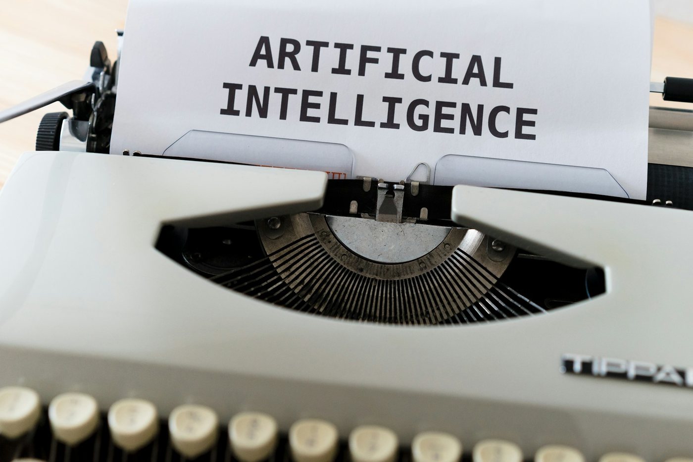 Typewriter paper with artificial intelligence text representing employer AI risk and accountability.